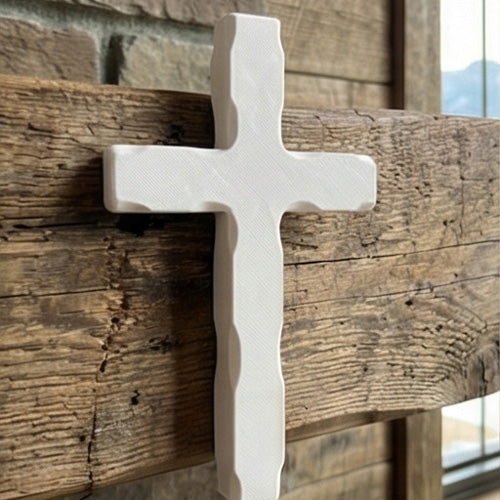 White cross on a wooden shelf with books and plants in a rustic setting